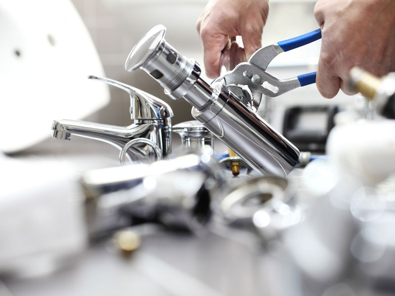 hands plumber at work in a bathroom